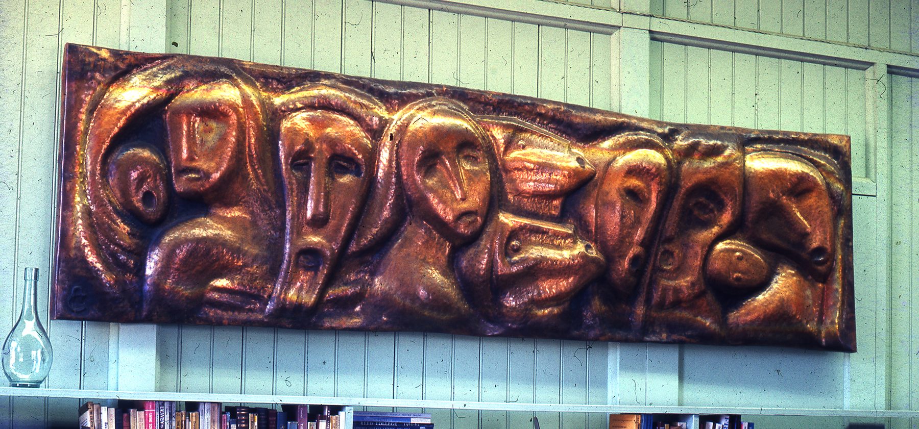 Family of Man Smooth abstract faces emerge from the copper sheet